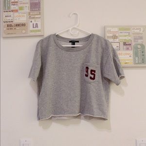 Gray shirt with red “95” patch on pocket